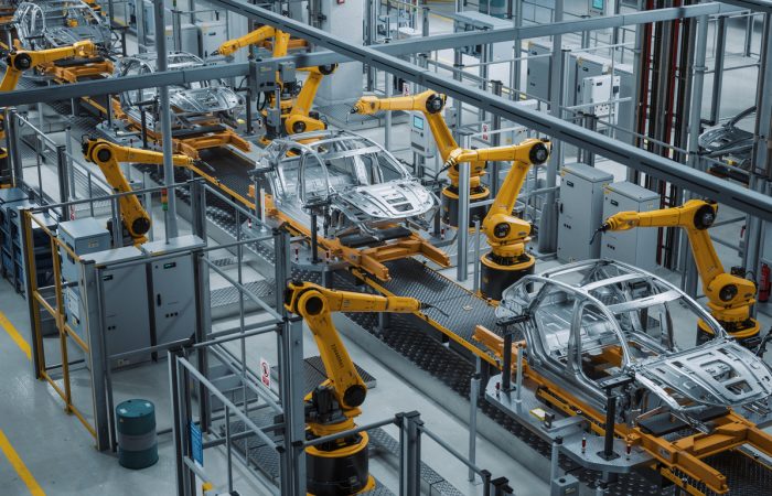 Car Factory 3D Concept: Automated Robot Arm Assembly Line Manufacturing High-Tech Green Energy Electric Vehicles. Construction, Building, Welding Industrial Production Conveyor. Elevated Wide Shot